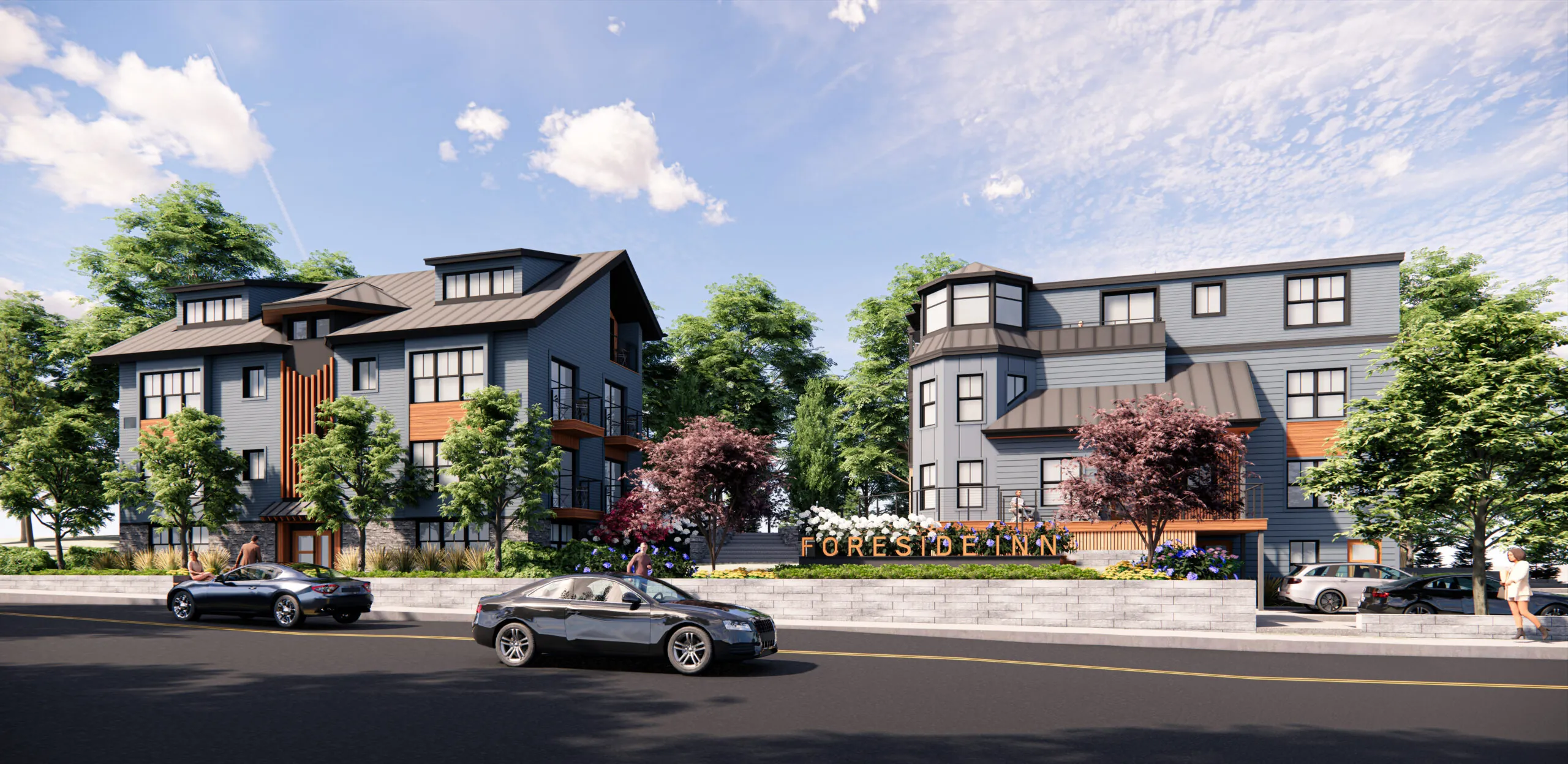 Modern apartment buildings with gray siding, large windows, and balconies, surrounded by trees and landscaping, with cars parked along the street.