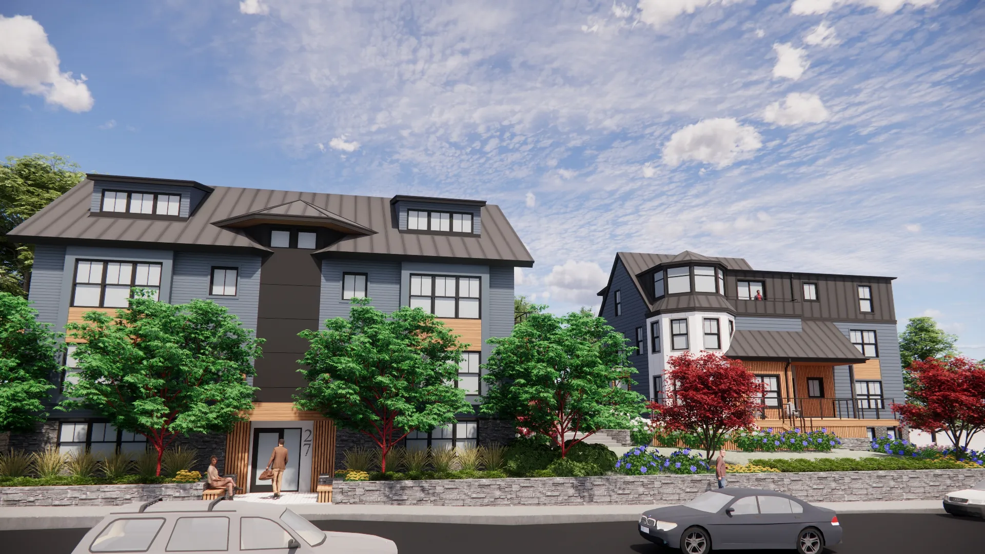 Modern apartment buildings with gray siding, large windows, and lush landscaping along a street with parked cars under a partly cloudy sky.