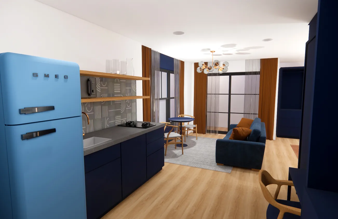 Modern studio apartment with a blue retro fridge, navy cabinets, wooden floors, a small kitchen, a sofa, and large windows with brown curtains.